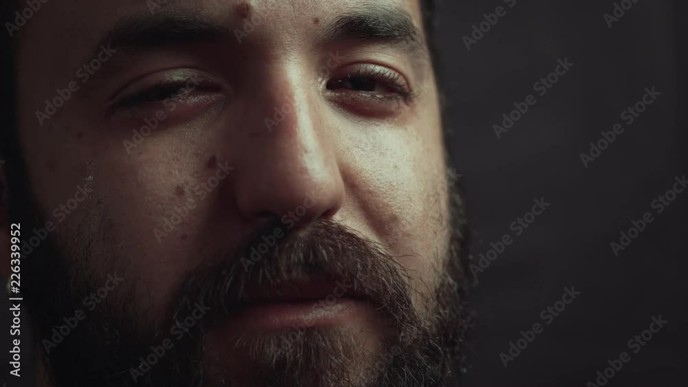 young bearded man crying and praying in the darkness young bearded man crying and praying in the darkness
