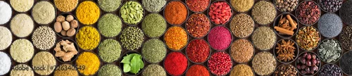 Obraz  z motywem Various spices and herbs as a background. Colorful condiments in cups, top view