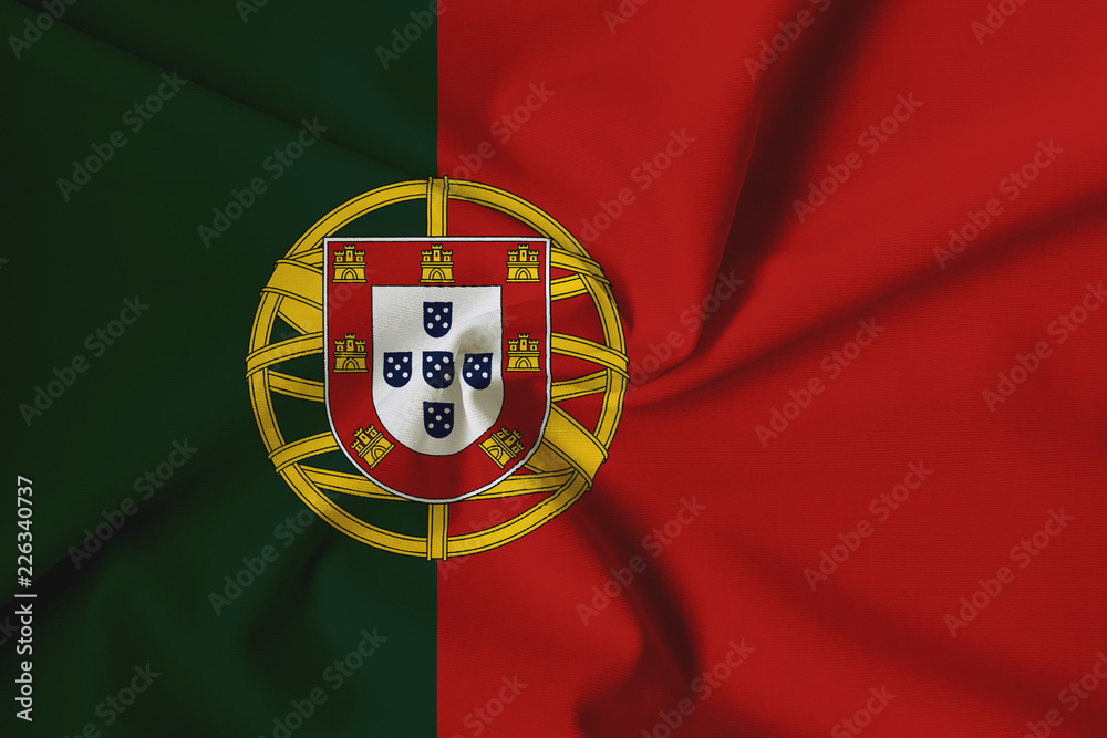 National flag of Portugal on a waving cotton texture background National flag of Portugal on a waving cotton texture background