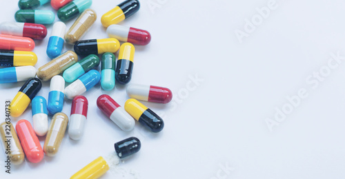 Antibiotic. Medicine capsules on white background with copy space. Drug prescription for treatment medication.