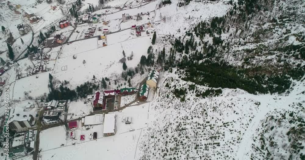 Aerial view of a house in the mountains. Carpathians. Snow. Winter. Bukovel. Ukraine. Aerial view of a house in the mountains. Carpathians. Snow. Winter. Bukovel. Ukraine.