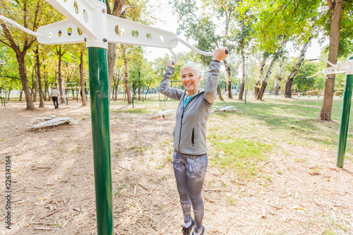 Fitness Senior Woman Exercise At Outdoor Gym