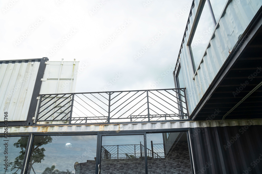 Fototapeta premium Modern metal building made from shipping house containers and blue sky background .