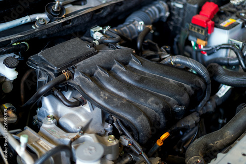 closeup detail of car engine with soft-focus and over light in the background