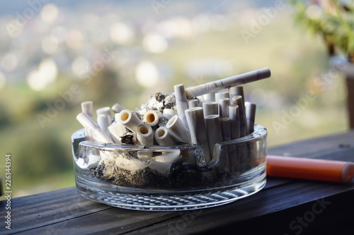 ashtray and cigarette on wooden table