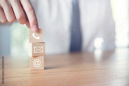 CONTACT US, Businessman hand holding ( mail,phone,email ) icon. cutomer support concept photo