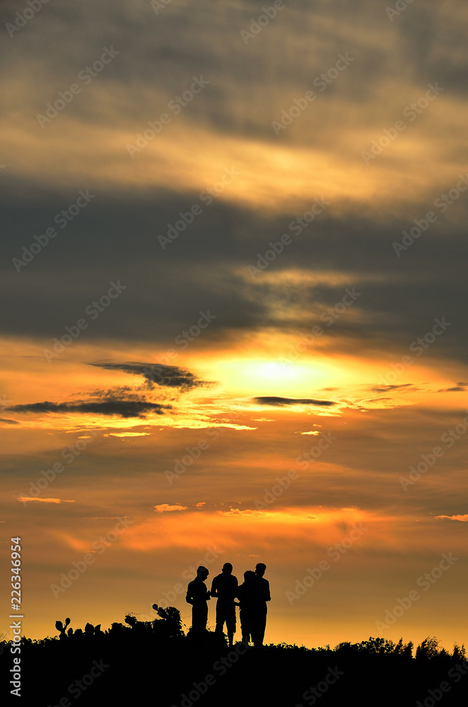 Village boys silhouette at sunset
