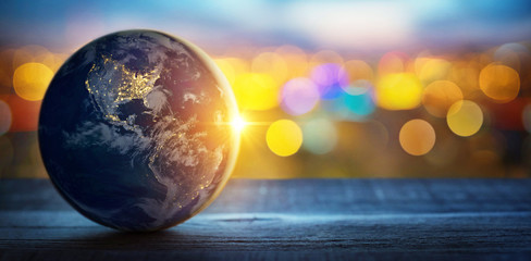 Planet earth on the background of blurred lights of the city. Concept on business, politics, ecology and media.  Elements of this image furnished by NASA