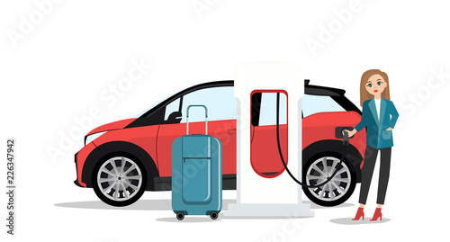 Woman traveler with baggage charges an electric car at a charging station. Isolated on white background.
