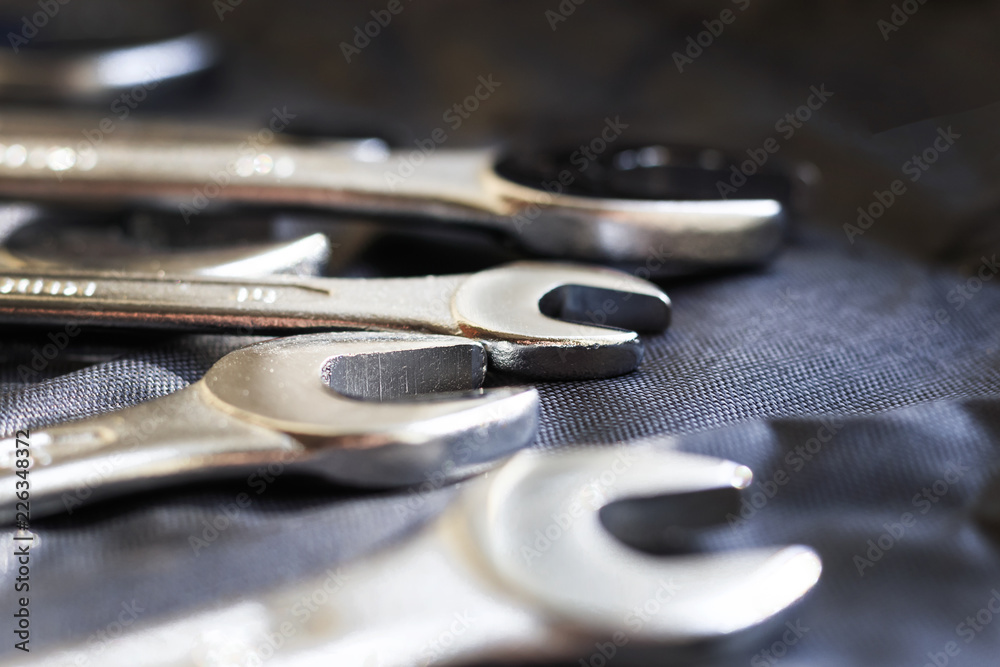 three keys for car repair, on a dark fabric background three keys for car repair, on a dark fabric background