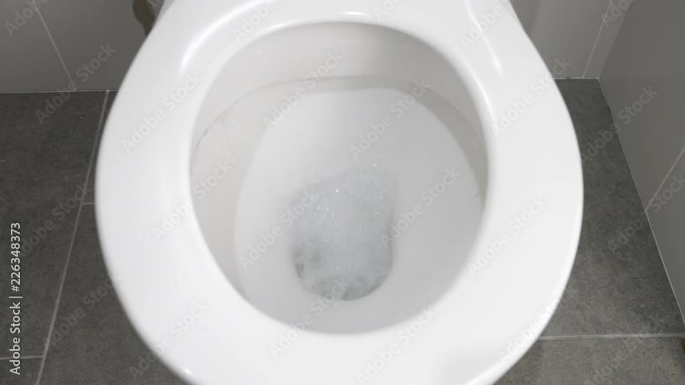 Water empties from a clean white toilet with complete flushing sequence Stock Video Adobe Stock