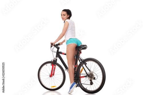 Fototapeta Naklejka Na Ścianę i Meble -  young athletic girl on a bicycle