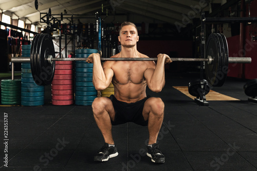 Muscular man during his weightlifting workout in the gym