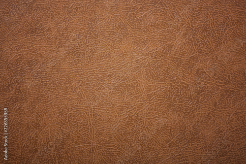 Brown or orange textured leather background. Abstract leather texture.