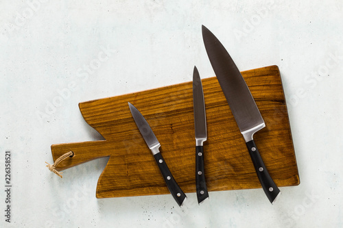 a set of knives on a wooden cutting board