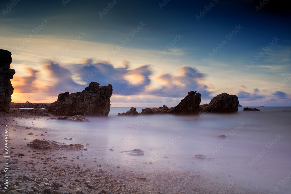 Seascape with motion wave and cloud at dawn