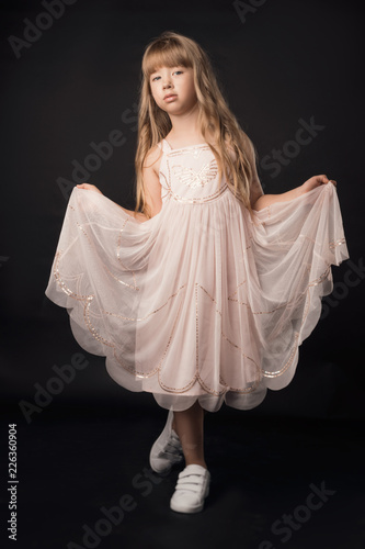 the child in the Studio posing in fashionable clothes