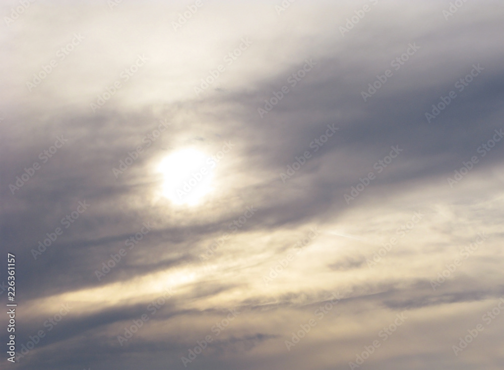 Dark clouds. The sun in a gloomy and tense sky. Bad weather.