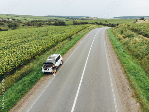 woman stuck with broken car in the middle of nowhere. © phpetrunina14