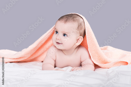 Baby girl or boy after shower with towel on head, isolated