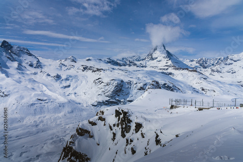 The famous mountain Matterhorn peak with cloudy and blue sky from Gornergrat, Zermatt, Switzerland