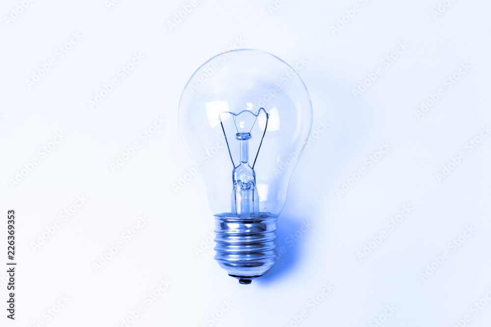 Blue toned incandescent lamp buld on light blue background with copy space Blue toned incandescent lamp buld on light blue background with copy space