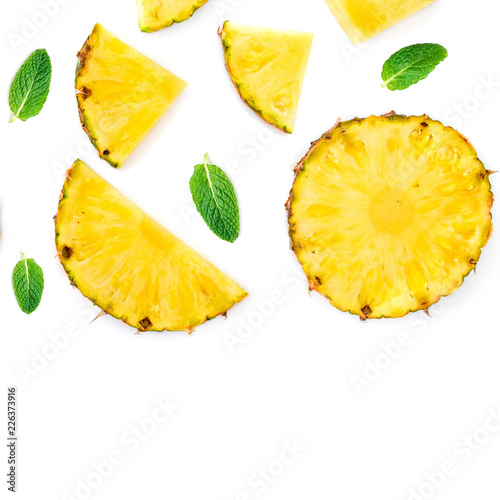 Sliced Pineapple Isolated.  Pineapple pieces  with green mint  leaves on white background. Flat lay. Summer concept .