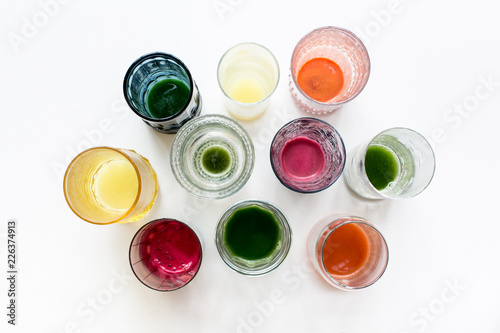 cups of freshly pressed juice on white background