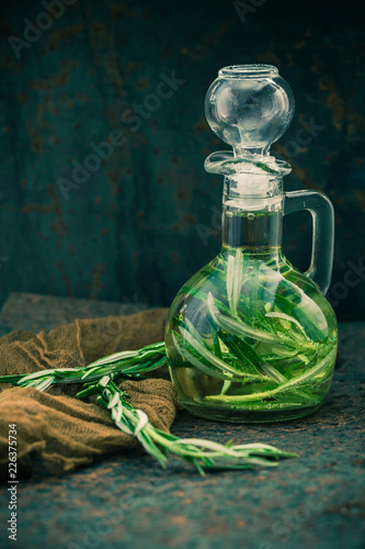 Olive oil bottle sprig rosemary photo