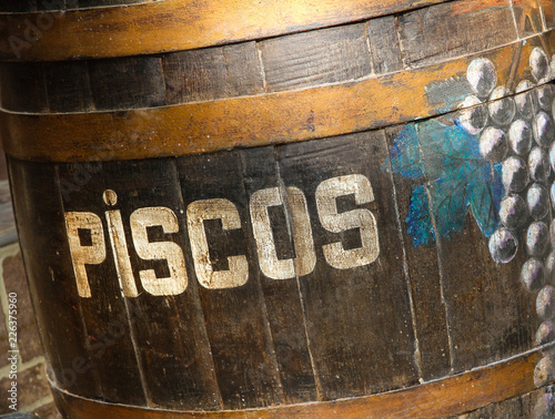 peruvian pisco barrel, close up with grapes and writing photo
