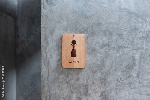 femel toilet sign on wood