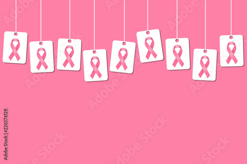 Breast cancer awareness background with hanging pink ribbon tags or cards on a pink background and space for text and headline. Pink ribbon cover template.