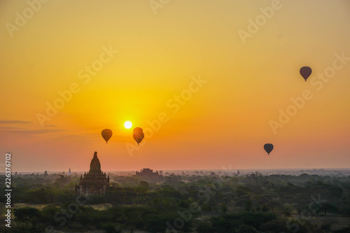 A beautiful sunrise with balloons floating in the air in Bagan is a city of thousands of Buddhist pagodas. Myanmar