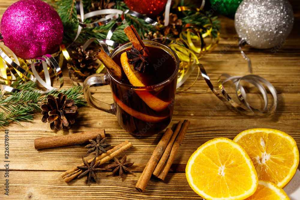 Christmas mulled wine with spices and Christmas decoration on wooden table Christmas mulled wine with spices and Christmas decoration on wooden table