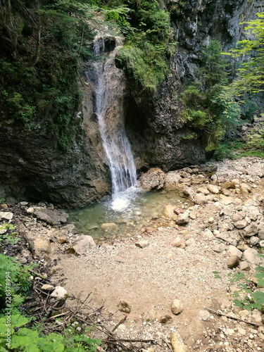 Wasserfall im Mischwald in der Schleifmühlklamm in schönster Natur im Sommer in Unterammergau bei Garmisch-Partenkirchen im Pfaffenwinkel in Oberbayern photo