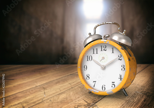 Retro alarm clock on wooden table