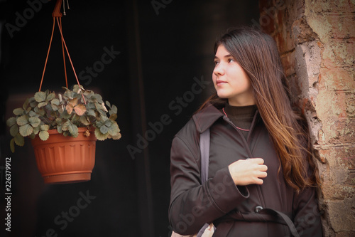 girl with long brown hair street photo walk on grafiti wall background