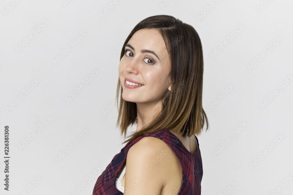Awe young brunette woman with beautiful smile posing against white background