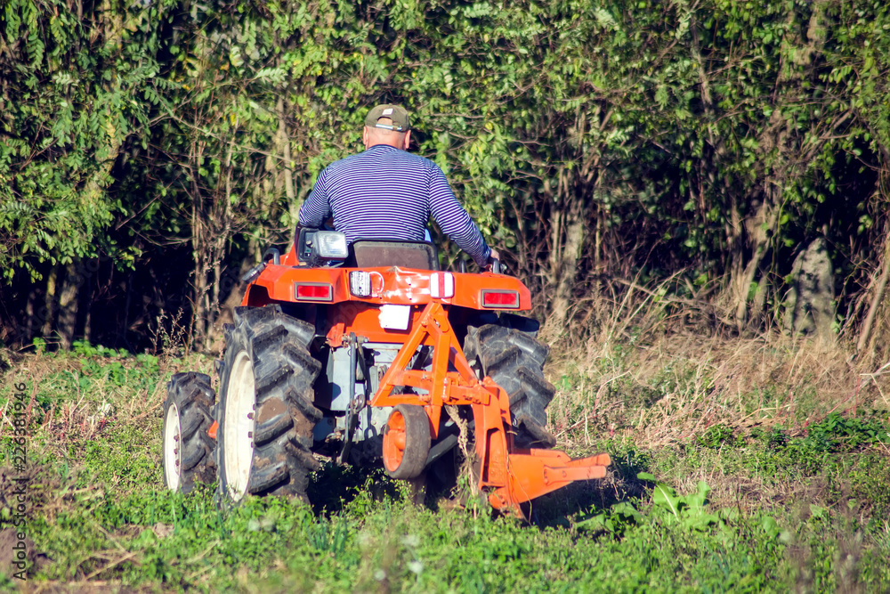 Obraz premium Tractor plowing fields -preparing land for sowing