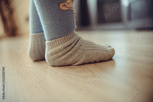 children's feet in socks are on the floor