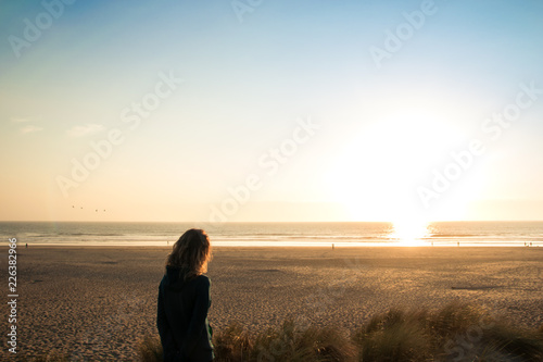 Girl Watching the sunset on a peaceful place © Henrique