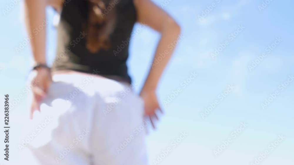 Girl with a beautiful figure undressed, against the sky in windy weather. Defocused Shot. Slow Motion Girl with a beautiful figure undressed, against the sky in windy weather. Defocused Shot. Slow Motion