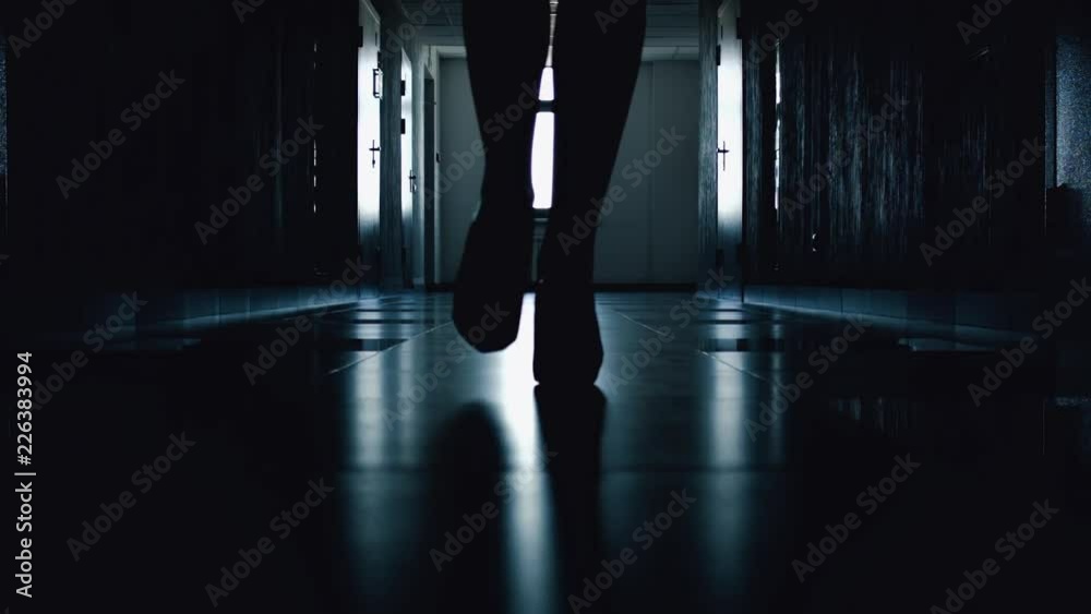 Close-up of silhouette of women's shoes with high thin heels of woman’s heels during walk down corridor. Light at the end tunnel. Exit from difficult situation. Solving business issues and problems.