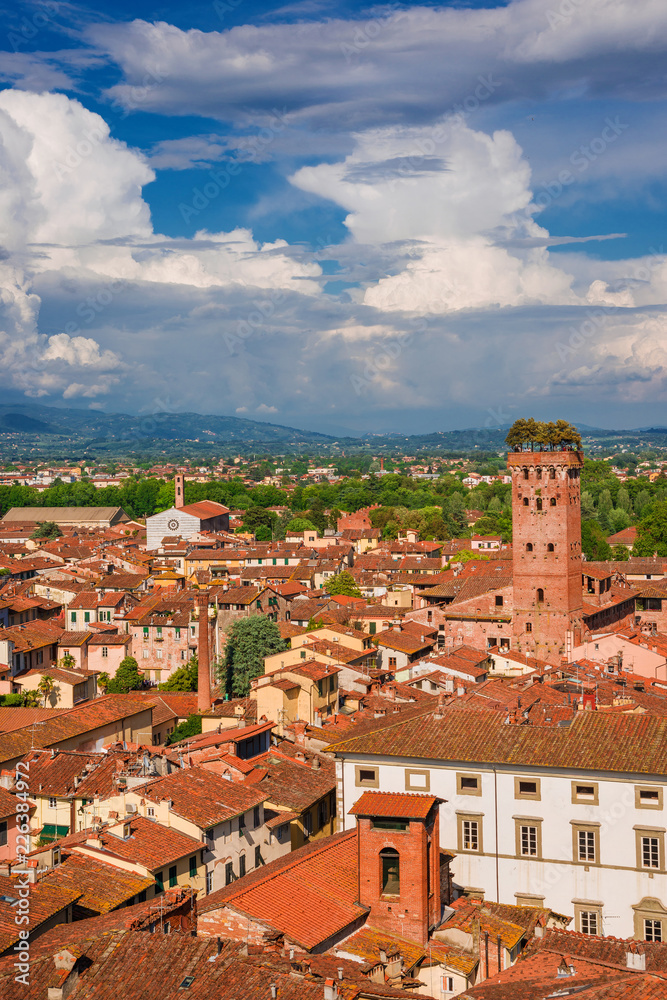 Lucca old  historic center skyline with medieval towers and clouds