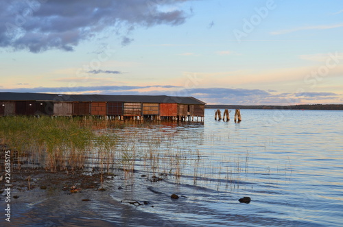 View of old boat sheds in a lake