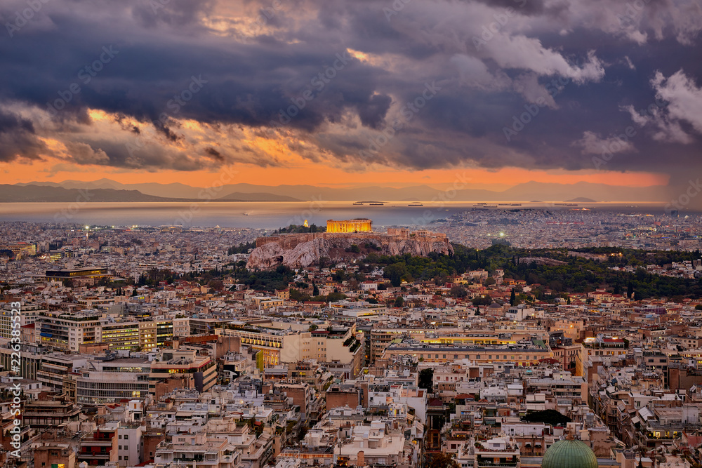 Illuminated Acropolis of Athens Greece at cloudy sky