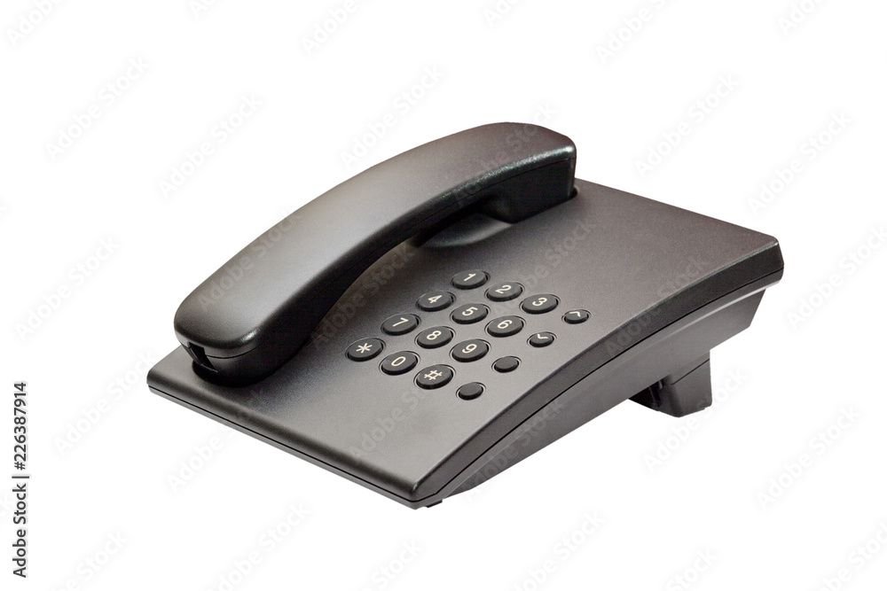 The image of black office phone with no cord on white background. The image of black office phone with no cord on white background.