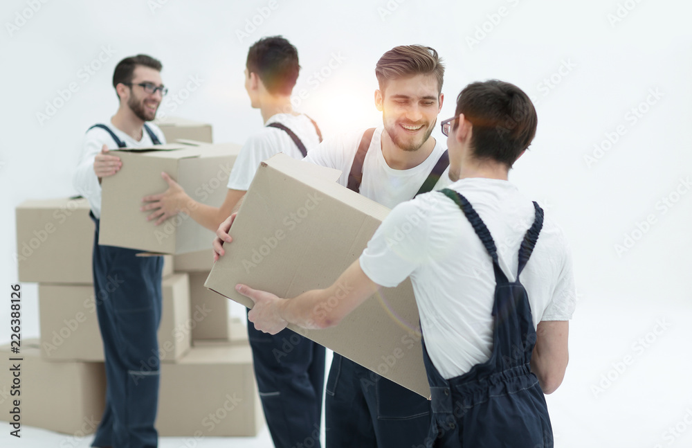 Portrait of movers holding box smiling isolated on white backgro Portrait of movers holding box smiling isolated on white backgro
