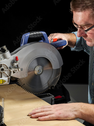 Cutting plank with mitre saw photo