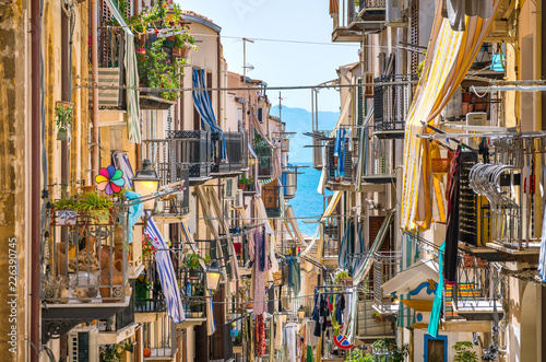Fototapeta Naklejka Na Ścianę i Meble -  A cozy street in Cefalù on a sunny summer day. Sicily, southern Italy.